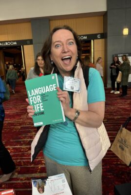 Lyn Stone holding her book, Language For Life