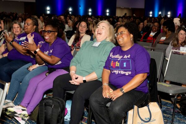 Conference audience members laughing and cheering at The Reading League 2024 Annual Conference