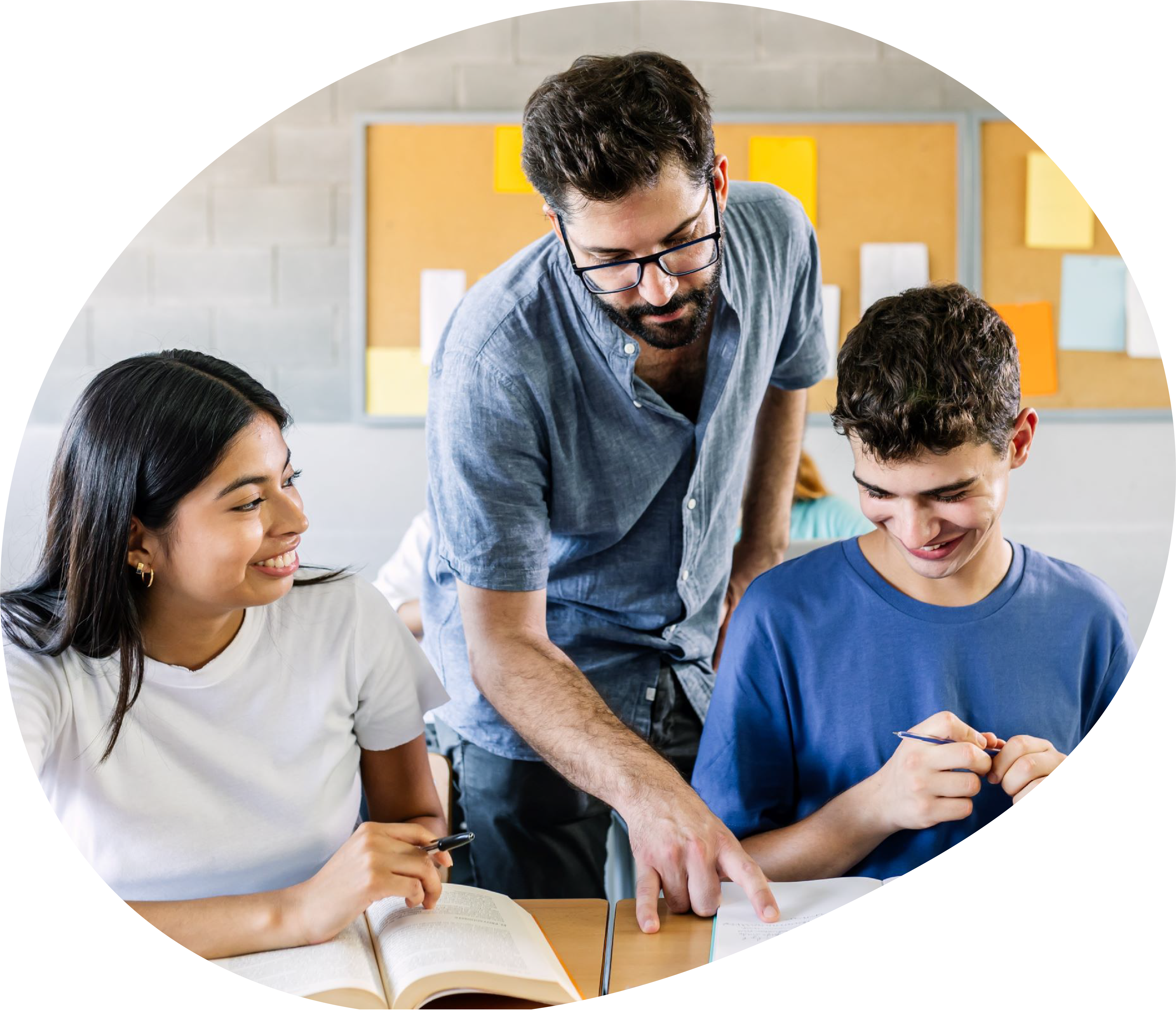 A teacher helps two teenage students read the text of their book