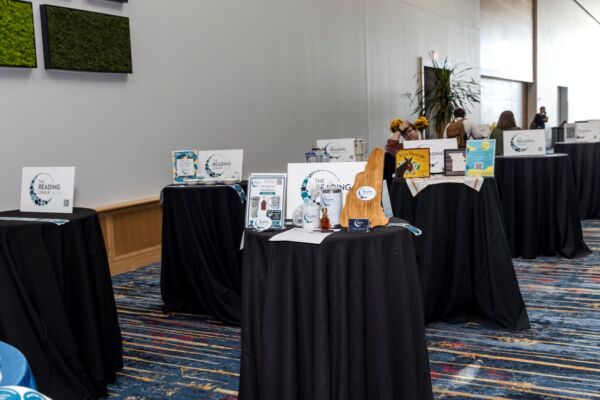 Tables with various items in a conference hall