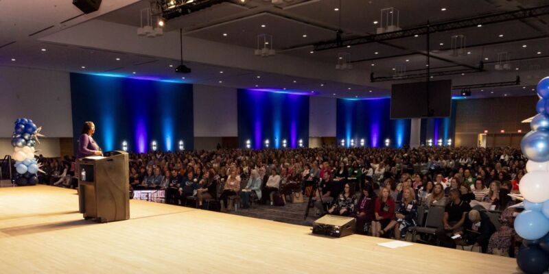 Person on stage speaking to a conference audience at The Reading League 2024 Annual Conference